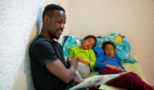 Parent reading to two children