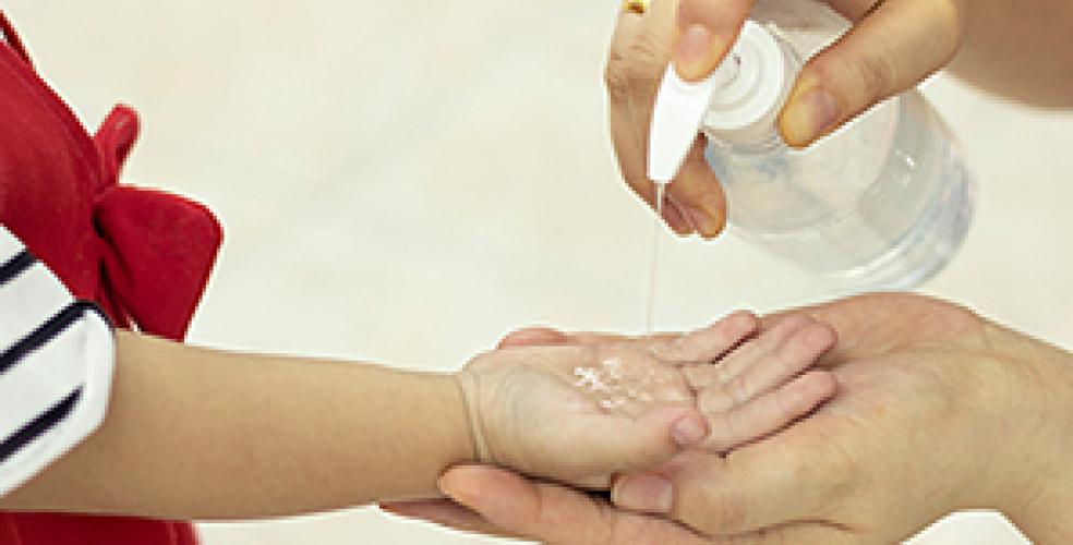 Child getting hand sanitizer